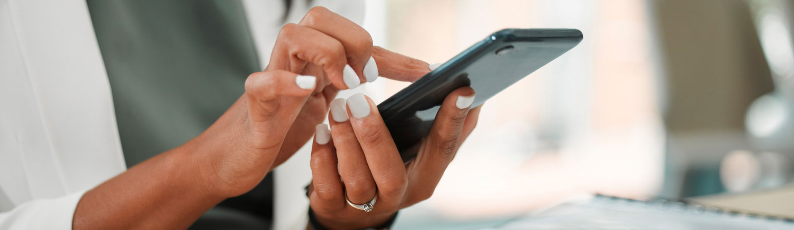 close-up of a woman's hands using a smartphone